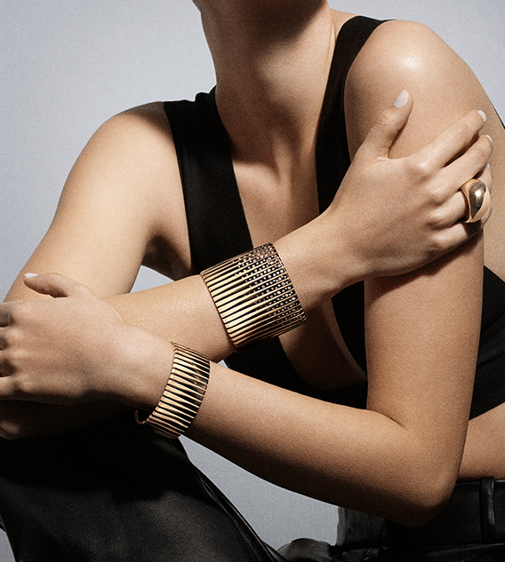 Woman wearing Vhernier gold bracelets and ring